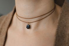 💎Black obsidian choker necklace 🌿Meaning: protection grounding transformation ✨This is a natural obsidian necklace in which the gemstone is wrapped with a high-quality wire. Fully adjustable with a sliding bead on a high-quality cotton cord.The stone is hand-picked and carefully crafted into a pendant. 🎨Colour ribbon / wire  Three different colours are available for the waxed cotton cord: -Beige (natural colour) -brown -black and two colours for the wire:  -Gold (gold-filled) -Silver (sterling silver) 🖤Natural raw obsidian Size: 8-10mm PLEASE take into account the natural variations of the crystals. As this is a natural product, size and colour may vary. Each stone is unique, just like you! Each piece will therefore differ from the picture.  ☀️ VISIT OUR SHOP: ☀️ https://www.etsy.com/s Raw Obsidian, Choker Handmade, Obsidian Necklace, Hand Wound, Choker Black, Perfect Gift For Girlfriend, Gemstone Choker, Natural Jewelry, Black Choker