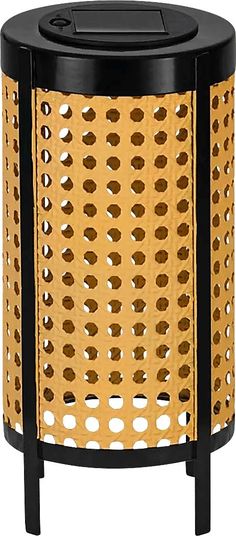 a black and gold trash can with holes on it