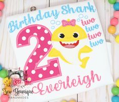 a birthday shirt with the number two in pink and yellow, featuring a smiling shark