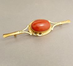 "Vintage 18k Gold & Coral Bar Pin Brooch Lapel Collar Pin Elegant Vintage, Italy 18K Yellow Gold Bar Pin Brooch Adorned With A Large Oval Bezel Set Coral  This Lovely Brooch Measures 3\" In Length 3/4\" W At The Center Tapering To 1/8\" Ends Hallmarked On The Reverse 750 For 18k  And Tested As Such Weight 8.7 Grams  jujubee1.etsy.com To Browse My Shop" Luxury Gold Brooches With Cabochon, Yellow Gold Art Deco Brooches For Formal Wear, Art Deco Yellow Gold Brooches For Formal Occasions, Oval Yellow Gold Brooches With Gemstone, Art Deco Yellow Gold Formal Brooches, Formal Art Deco Yellow Gold Brooches, Luxury Yellow Gold Cabochon Brooches, Luxury Hallmarked Oval Brooch, Antique Yellow Gold Hallmarked Brooches