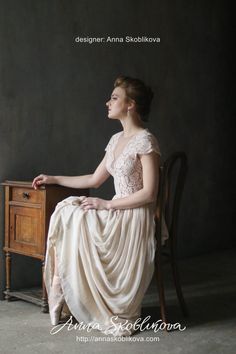 a woman sitting on top of a wooden chair