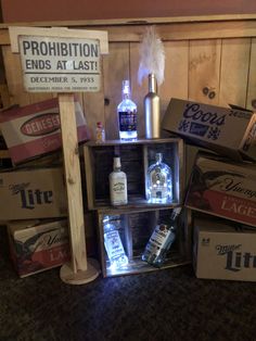 several liquor bottles are stacked on top of boxes