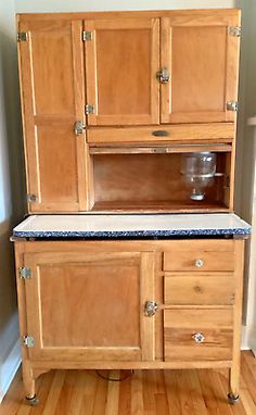 an old fashioned wooden cabinet with granite top