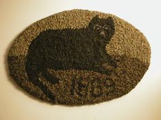 a door mat with a black cat on it