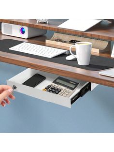 a desk with a keyboard, mouse and phone on it