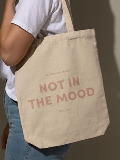 Our Not In The Mood Canvas Tote Bag is the ultimate accessory for when you’re going out but don’t actually want to deal with anyone. Want more Uncommon James merch and tote bags? Shop all of our apparel and accessories. Tote Bag Product Photography, Tote Bag Photography, Tote Bag Accessories, Content Inspiration, Uncommon James, Moodboard Inspiration, Not In The Mood, Totes Bag, Bag Designs