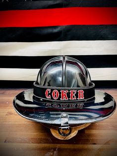 a fireman's hat sitting on top of a skateboard in front of an american flag