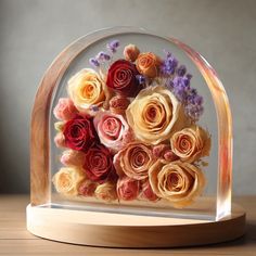 there is a glass dome with flowers in it