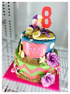 a colorful birthday cake with the number eight on it