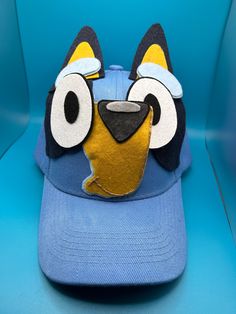 Custom made Bluey inspired hat!  Adjustable adult size. Made from a cotton-poly blend, felt and other craft items. Made to order.  Adjustable hat size from 17-24 inches, or 43-61 cm. Velcro closure Laundering information: recommend carefully spot cleaning with gentle cleanser if soiled Bluey Hat, Bingo And Bluey, Felt Hats, Gentle Cleanser, Felt Hat, Craft Items, Adjustable Hat, Hat Sizes, Trucker Cap