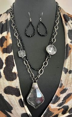 "Artisan Zen Hand Forged Faceted Crystal chandelier Southwestern Pendant with Rolo gunmetal chain and black faceted onyx gemstone with earrings handmade boho set. Beautiful handmade soldered chandelier faceted dangle measures 58mm x 36mm and hangs from a big oval Rolo gunmetal organic chain circle links measuring 10mm x 14mm.   The chain measures 25\" and can be adjusted.  The second row is made of 3mm faceted black onyx gemstone beads and measures 24\".  There are two accent faceted clear cryst Black Metal Teardrop Necklace, Black Teardrop Metal Necklace, Black Bohemian Jewelry With Faceted Beads, Bohemian Silver Jewelry With Hematite, Nickel-free Black Hematite Jewelry, Black Teardrop-shaped Jewelry With Faceted Beads, Black Teardrop Jewelry With Faceted Beads, Black Faceted Beads Dangle Jewelry, Black Dangle Jewelry With Faceted Beads