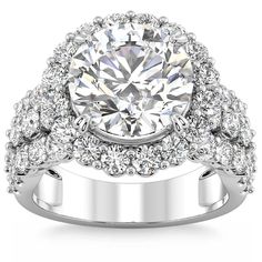 a diamond ring with two rows of diamonds on the band and an oval center stone