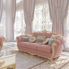 an elegant living room with pink couches and gold trimmings, along with large windows