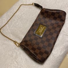 Like New , Worn A Handful Of Times. No Scuffs Or Peeling . Damier Ebene Canvas. Red Interior Canvas . Dark Brown Leather And Gold-Tone Hardware. Features A Removable Shoulder Strap, And A Chain Link Shoulder Strap To Carry The Bag As A Clutch. Comes With Dust Cover, Leather Strap, And Gold Chain . Louis Vuitton Eva Clutch, Louis Vuitton Eva, Red Interior, Red Interiors, Damier Ebene, Dark Brown Leather, Dust Cover, Michael Kors Jet Set, Authentic Louis Vuitton