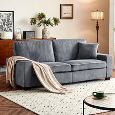 a living room with a gray couch and coffee table on the floor next to it