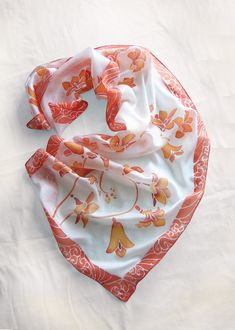 White kimono scarf with Freesia orange and coral flowers was hand painted on pure silk. How about a gift for your gardener friend? Size: 61 by 17 inch (155 by 43 cm) Silk: 100% natural Habotai Light (semi-transparent, delicate and a bit glossy), hand painted with silk paints that won't fade in the sun. The design is visible on both sides. This silk scarf was designed as my impression over Japanese kimono silk painting art. The color composition is simple and refreshing. You can see orange flower White Silk Scarf With Floral Print For Gift, White Floral Print Silk Scarf As A Gift, White Floral Print Silk Scarf For Gift, White Artistic Handmade Scarves, Orange Silk Scarf For Summer Gift, White Hand Painted Silk Scarf Gift, Artistic Handmade White Scarves, Artistic Hand-painted White Scarf, Artistic Hand Painted White Scarf