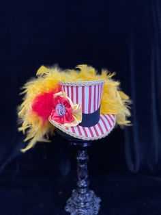 Step right up to see this over-the-top Circus Mini Top Hat!! With it's red and white stripes and oodles of feathers it is sure to be a crowd pleaser! This little beauty measures approximately 4 1/2 inches tall x 6 inches wide x 7 inches deep. Please note the shipping times as this item is made to order. Adjustable Red Mini Hat For Carnival, Red Costume Hats For Carnival, Adjustable Red Costume Hats And Headpieces For Carnival, Adjustable Red Costume Hats For Carnival, Red Feathered Costume Hat, Red Carnival Costume Hat, High Crown Top Hat For Carnival, Mini Hats, Mini Top Hat