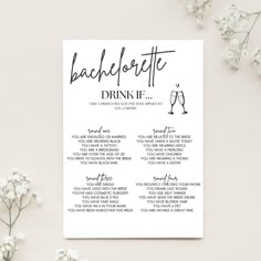 the bachelor drink list is displayed on top of a white tablecloth with flowers around it