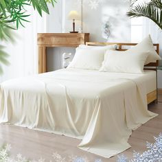 a bed with white sheets and pillows in a room decorated with snowflakes