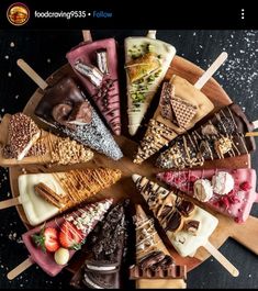 a wooden platter filled with lots of different types of desserts