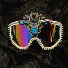 Introducing the Scarab Goggle A truely beautiful piece. Only one available for the moment so catch it whilst you can! Perfect for ski season, festival season, or shielding your eyes in dust storms!  Can be also worn as an eye catching  headpiece!  * Ski style goggles with elasticated band and sponge inner rim for the perfect comfortable fit  * studded edge and rhinestone centrepiece featuring a beautiful sparkling beetle (or scorpion as an alternative)  * personalisation options: change of stud Skyrim Costume, Space Viking, Ski Style, Burning Man Fashion, Dust Storm, Rave Accessories, Gold Skull, Ski Season, Outfit Plan