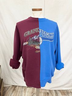 Half and half blue and burgundy sweatshirt. Size M/L Purple Graphic Print Sweater For Fall, Purple Graphic Print Sweatshirt For Fall, Burgundy Crew Neck Top For Layering, Purple Winter Tops For College, Purple Winter College Tops, Fall Graphic Print Sweatshirt For Layering, Blue Varsity Sweater For Fall, Purple Tops For College In Fall, Blue And Burgundy