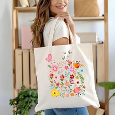 ABOUT OUT-------------Tote bag de mujer con gráfico de flores silvestres coloridas. This design was created with a base of an embroidery design taken from my  inspiration, tote bags with some modifications to the original design creating a unique pattern for your searching expectations. This 100% cotton bag comes in one size - 15" x 16"- perfect for everyday wear. While the canvas material will show off your designs in great colors, it's durable and will last for years. The bag features 20" hand Spring Multicolor Canvas Bag With Large Capacity, Spring Multicolor Large Capacity Canvas Bag, Large Capacity Multicolor Canvas Bag For Spring, Multicolor Canvas Shoulder Bag For Spring, White Floral Print Tote Bag, White Floral Print Tote Shoulder Bag, White Floral Print Shopping Bag, Casual White Bag With Floral Print, Spring Floral Print Everyday Bags