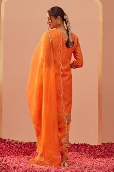 Tangerine orange kurta with tilla, patra, foil mirror embroidery in floral pattern. Paired with floral hand block print salwar and dupatta.
Components: 3
Pattern: Embroidery, Hand Block Printed
Type Of Work: Tilla, patra, foil mirror, floral
Neckline: Notched
Sleeve Type: Three quarter
Fabric: Kurta: Silk Chanderi, Salwar: Bamberg Satin, Dupatta: Silk Organza
Color: Orange
Other Details: 
Scallop bordered sheer dupatta
Lace embroidered cutwork hem
Occasion: Sangeet - Aza Fashions Orange Dola Silk Sets With Resham Embroidery, Orange Sets With Resham Embroidery In Traditional Drape, Orange Resham Embroidery Sets For Navratri, Festive Orange Sets With Resham Embroidery, Orange Dola Silk Sets For Festivals, Orange Designer Wear Sets With Traditional Drape, Orange Chanderi Wedding Sets, Orange Chanderi Set With Gota Work, Orange Chanderi Sets For Festivals