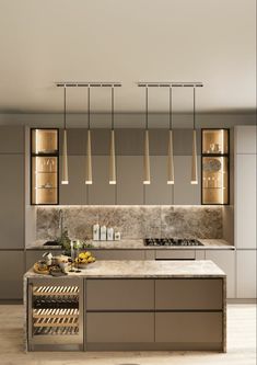 a modern kitchen with marble counter tops and stainless steel appliances, along with hanging lights