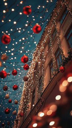 This close-up of a building covered in lights and red ornaments just screams Christmas magic, making it perfect for a cozy winter wallpaper. Winter Phone Backgrounds Wallpapers, Winter Wallpaper Iphone, Red And Gold Ornaments, Christmas Wallpaper Ideas