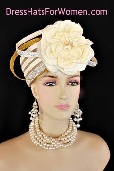 Ladies 1920's Style Flapper Art Deco Era Ivory Metallic Gold Pillbox Church Wedding Bridal Cocktail Hat. This Formal Straw Braid Hat Is Embellished With A Large Ivory Double Loop Bow Enhanced With Clear Acrylic Rhinestones, Accented With Two Metallic Gold Double Looped Bows. A Large Ivory Millinery Silk Flower With A Large Pearl Center Is Placed In The Center Of This Beautiful Custom Made Bow.  Four Rows Of Rhinestones Encircle The Crown Of This Fashion Wedding Headpiece. This Designer Hat Is Suited For A Bride To Be On Her Wedding Day Or For A Wedding Guest. A Beautiful Dress Hat To Wear To Church, Formal, Horse Races, The Kentucky Derby And Formals. This Dress Couture Hat Is Custom Made And Designed By Dress Hats For Women, https://dresshatsforwomen.com

Crown Measures:   This Is A Vinta Double Loop Bow, Special Occasion Hats, Mother Of The Bride Hats, Flapper Art, Custom Made Hats, Occasion Hats, Bridal Fascinator, Couture Hats, Bridal Hat