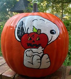 an orange pumpkin with a cartoon character painted on it