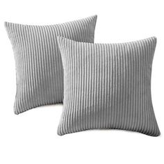 two gray pillows sitting next to each other