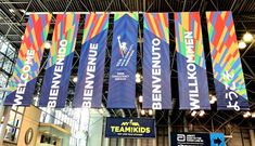 several banners hanging from the ceiling in a building