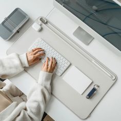 a woman is typing on her computer keyboard