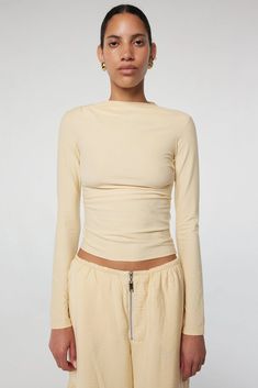 Selma: High neck, slim long sleeves in a cotton-modal blend. Effortless drape with hand-pleated details. 45% Cotton 45% Modal 10% Spandex. Versatile Long Sleeve Top With Soft Stretch, Versatile Soft Stretch Long Sleeve Top, Chic Fitted Long Sleeve Top With Ruched Details, Stretch Elastane Long Sleeve Top For Fall, Chic Fitted Ruched Long Sleeve Top, Chic Ruched Long Sleeve Fitted Top, Long Sleeve Tops With Minimal Stretch For Layering, Long Sleeve Tops For Layering With Minimal Stretch, Stretch Ruched Long Sleeve Blouse