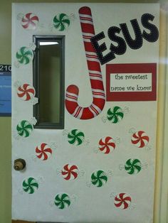 a door decorated with candy canes and the word jesus