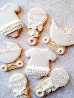 cookies decorated with white icing and bows on top of a sheet of paper next to an instagram post