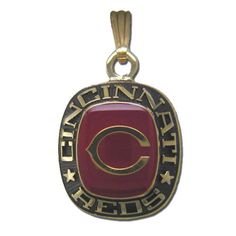 a red and gold charm with the word,'team chiefs'written on it