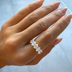 a woman's hand with a diamond ring on it