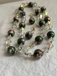 This is a vintage estate jewelry set including a 30" cloisonne beaded necklace with crystal beads in between the cloisonne beads, and a set of matching cloisonne bead wire earrings measuring a 1.75" drop.  The closure on the necklace is an  inset clasp. The necklace is fairly heavy - made with quality cloisonne and crystal beads. The clasp is marked 14/20. This is a lovely rare cloisonne set because of the crystal beads. Please contact me if you have any questions. Cloisonne Jewelry, Bead Wire, Wire Earrings, Estate Jewelry, Crystal Beads, Jewelry Set, Jewelry Sets, Etsy Earrings, Beaded Necklace