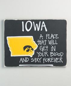 a black and yellow magnet with the words iowa on it