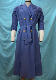 "1940s/1950s W:28 vintage army military women's waves naval uniform dress coat collared golden buttons American eagle tailored  Great and rare vintage 40s uniform U.S. Navy Women's Waves dress coat. Beautifully tailored design in thick cotton chambray in Blue Jay coloring. A-line silhouette of paneled construction with exquisite golden buttons reserved for navy only picturing anchor and American eagle. Take a look on the back tailoring and seams. Double breasted with built in belt tie. 3/4 sleeve with reverted seam. Photographed on fitting form size 2, check measurements. MEASUREMENTS  Bust: 38\" Waist: 28\" Hips: 40\" Length: 44\" with 3\" hem available This is in good vintage condition, there's a few small pin holes and some light overall wear to cotton. Some fading throughout, some loos Fitted Military Pea Coat With Buttons, Fitted Blue Peacoat With Buttons, Fitted Double-breasted Peacoat With Buttons, Vintage Fitted Peacoat With Buttons, Fitted Vintage Peacoat For Work, Vintage Fitted Pea Coat With Buttons, Vintage Peacoat With Buttons For Workwear, Fitted Vintage Pea Coat With Buttons, Fitted Vintage Pea Coat