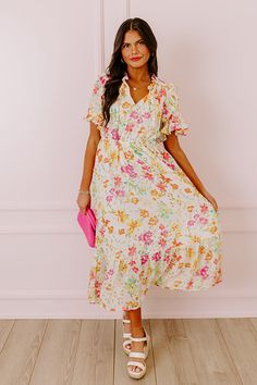 - Drape yourself in petals and twirl in the sun with this airy dress! - Chiffon material with a colorful abstract floral print - A built-in lining that ends above the ruffled hemline - A ruffled v-cut neckline with a tie detail - Short, loose ruffled sleeves - Pleated detail at the bodice - An elastic waistline - A flowy yet flattering silhouette that ends in a ruffled maxi length hemline Flowy Multicolor Midi Dress With Ruffles, Tiered Chiffon Floral Dress With Floral Print, Multicolor Chiffon Floral Dress For Garden Party, Feminine Multicolor Floral Print Midi Dress, Feminine Multicolor Floral Midi Dress, Breezy Ruffle Hem Dress For Garden Party, Multicolor Floral Chiffon Midi Dress, Multicolor Floral Print Chiffon Midi Dress, Flowy Multicolor Dress With Ruffle Hem