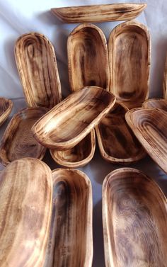 a pile of wooden plates sitting on top of a table