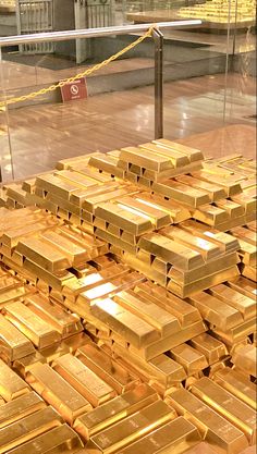 a pile of gold bars sitting on top of a wooden floor