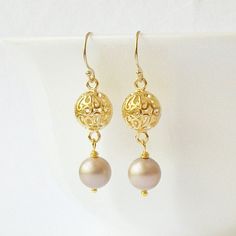 Limited: One Pair Love these unique pretty neutral taupe/beige and gold earrings! Beige (Swarovski color: Powder Almond) Swarovski crystal pearls Measure from top to bottom: 1.5 inches Plastic Safety Ear nuts included. Earrings arrive in a gift box, with ribbon and blank card, ready for gift giving! Thank you for stopping by Perini Designs Studio! http://www.etsy.com/shop/PeriniDesigns *Copyright on all original designs and photographs held by artist. Elegant Gold Pearl Earrings Nickel-free, Elegant Gold Pearl Earrings Nickel Free, Elegant Beige Nickel-free Earrings, Elegant Cream Earrings Nickel Free, Elegant Cream Nickel-free Earrings, Gift Box With Ribbon, Box With Ribbon, Earrings Pearl, Color Powder