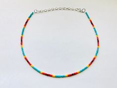 This sunset themed boho necklace is made with  turquoise, yellow, orange, and red glass seed beads to create a cool sunset effect.  It comes in four different lengths (14, 16, 18, or 20 inches) and each necklace also comes with three additional inches of extender chain.  This summer necklace brings out the beach vibes all year round! Get yours today for yourself or as a gift for a friend or family member! Summer Spacer Bead Choker Jewelry, Bohemian Summer Jewelry With Spacer Beads, Beach Turquoise Heishi Beads Necklace, Bohemian Rainbow Choker Necklace, Vacation Colorful Beads Choker, Adjustable Rainbow Necklace For Summer, Yellow Bohemian Jewelry For Vacation, Summer Adjustable Rainbow Necklace, Colorful Tiny Beads Jewelry For Festival