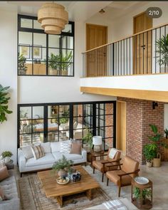 a living room filled with lots of furniture and plants on top of it's walls