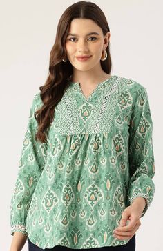 Green & White unique Jaipuri Cotton Print handmade top,features 3/4th sleeves and is mid length. extremely stylish and comfortable for every occasion,looks amazing with shorts or denims.This blouse is comfort & stylish .refer to the size chart or drop us a message if you need assistance. The beautiful detailing on the neck with the hand done embellishing and lace add a vintage boho chic look , while the print is eye catching as well  Model is wearing size S Also available in  S,M,L,XL Size chart Summer Tunic Tops With Printed Motifs, Casual Long Sleeve Blouse With Printed Motifs, Summer Tunic Blouse With Printed Motifs, Spring Tunic Blouse With Printed Motifs, Green Printed Half Sleeve Blouse, Summer Casual Straight Kurta Blouse, Spring Straight Kurta Blouse With Printed Motifs, Casual Green Straight Kurta Top, Bohemian Printed Half Sleeve Tops